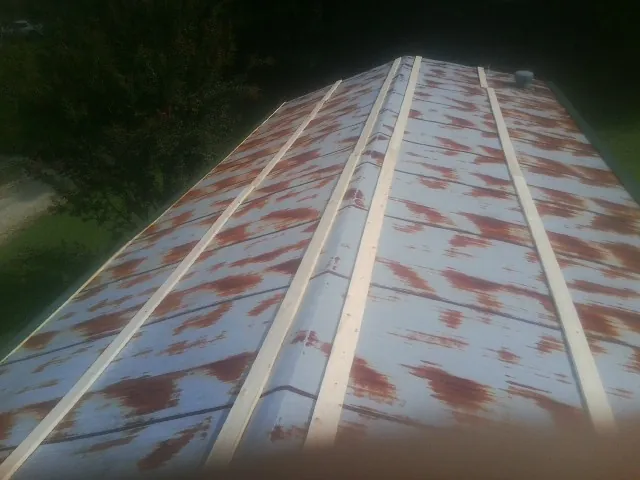 Rusted metal roof panels with new wood purlins before replacement — Storm Damage Roof Repair in New Rochelle by Roofing Brothers