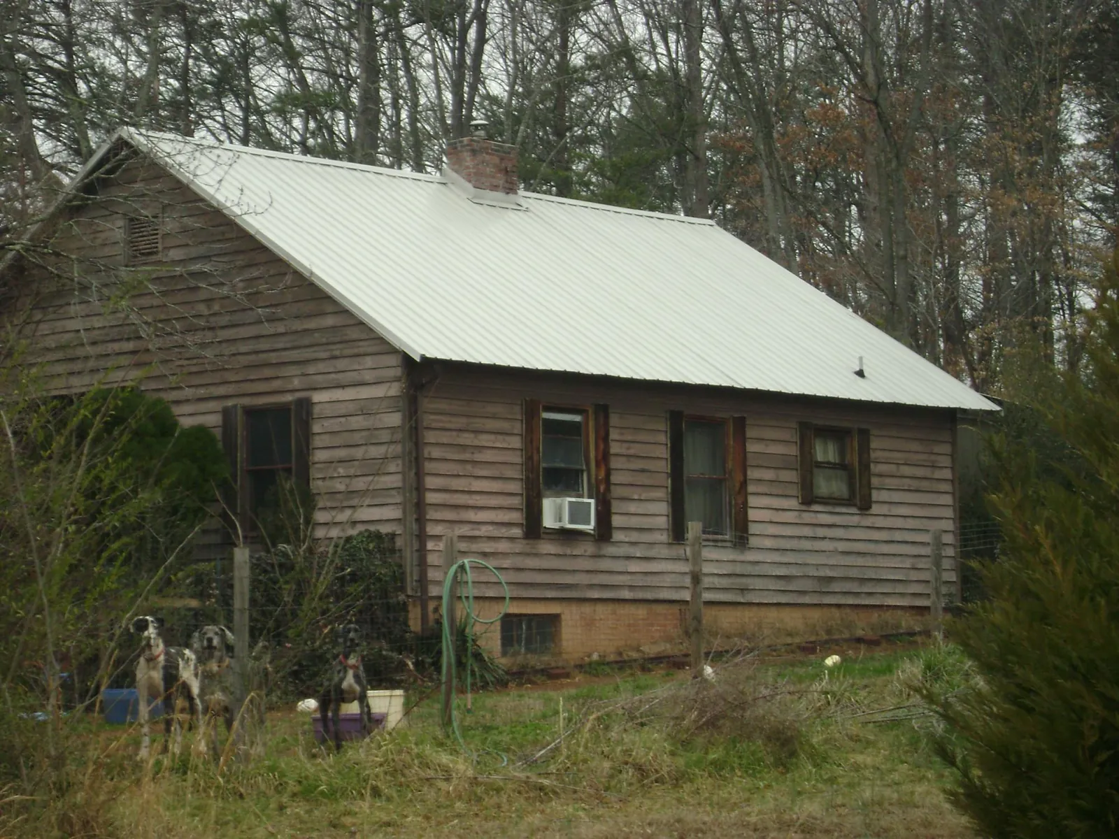 White metal roof on an old wood sided farmhouse, from a Metal Roof Installation job in New Rochelle